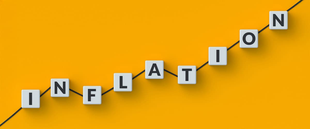 Letter tiles spelling Inflation along a rising line on a yellow background